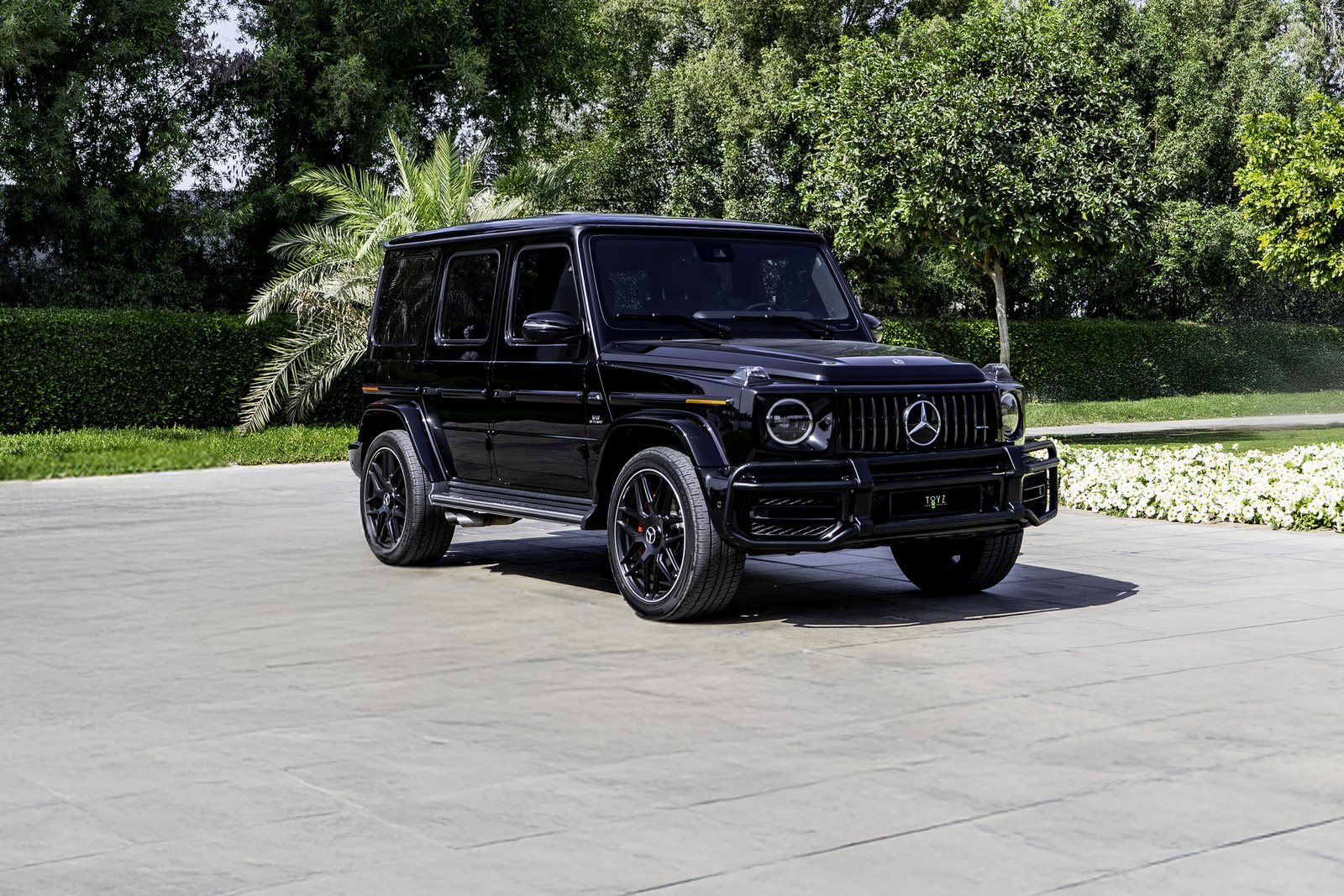 Black Mercedes-AMG G63 from the Dynasty Prestige fleet standing ready on a paved forecourt before a guest handover