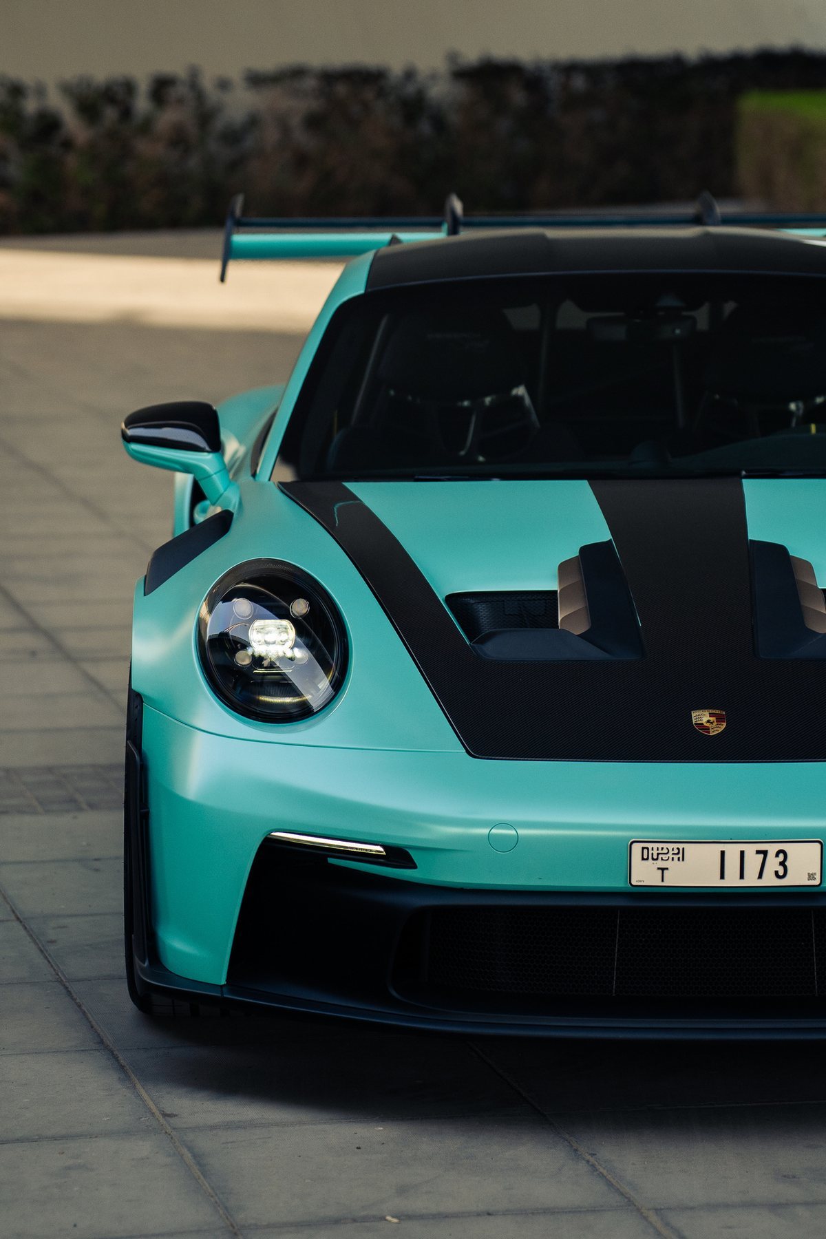 Blue Porsche 911 GT3 RS from the Dynasty Prestige fleet with its Dubai plate, checked before a rental handover