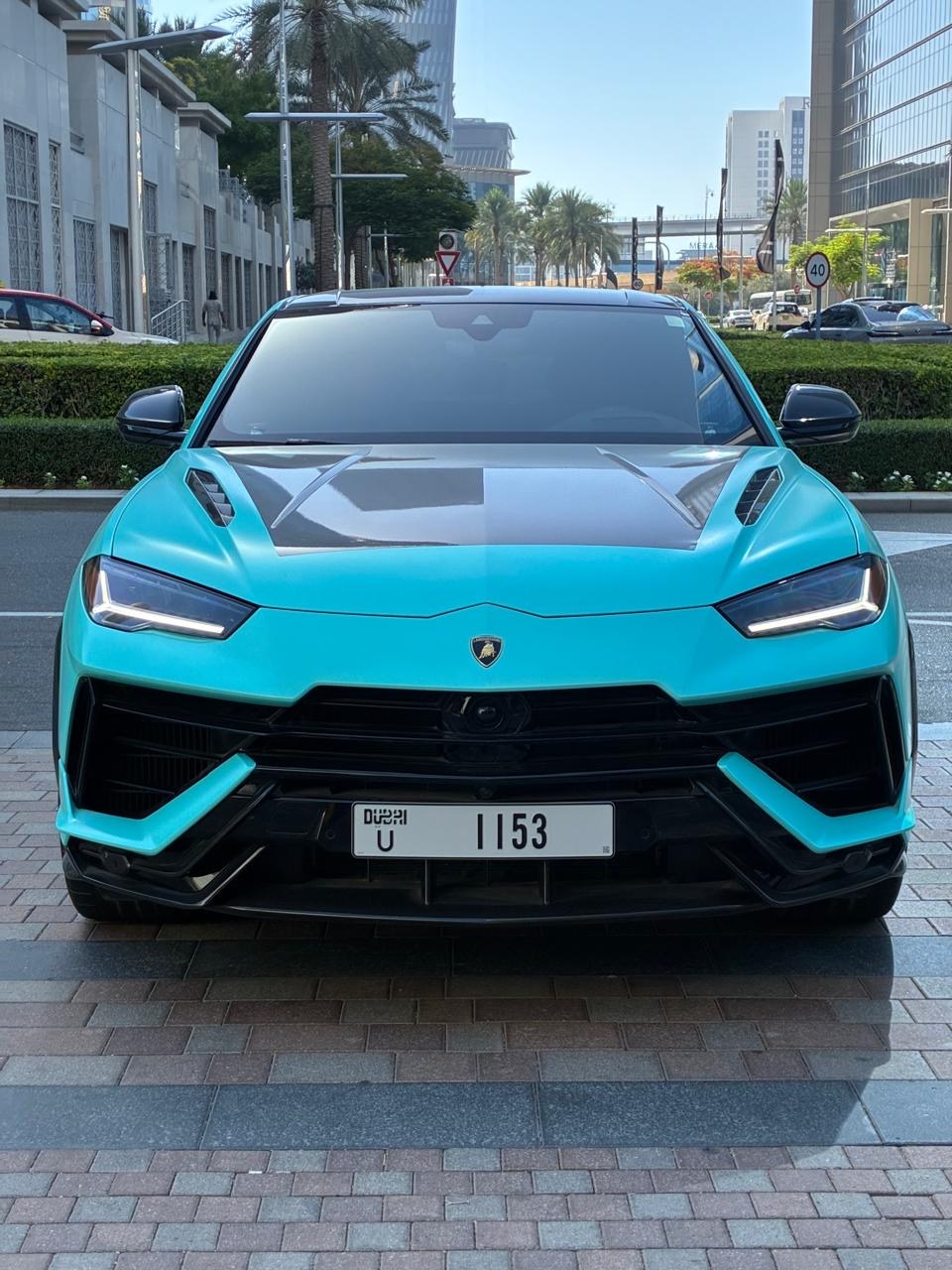 Turquoise Lamborghini Urus SUV front view available to rent in Dubai
