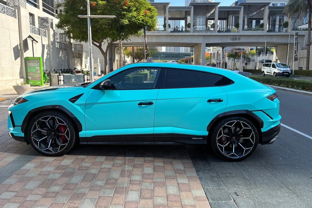 Turquoise Lamborghini Urus SUV side stance in Dubai